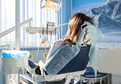 woman getting a routine dental checkup and cleaning for implants in Geneva
