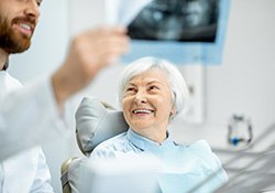 woman smiling while getting dental implants in Geneva